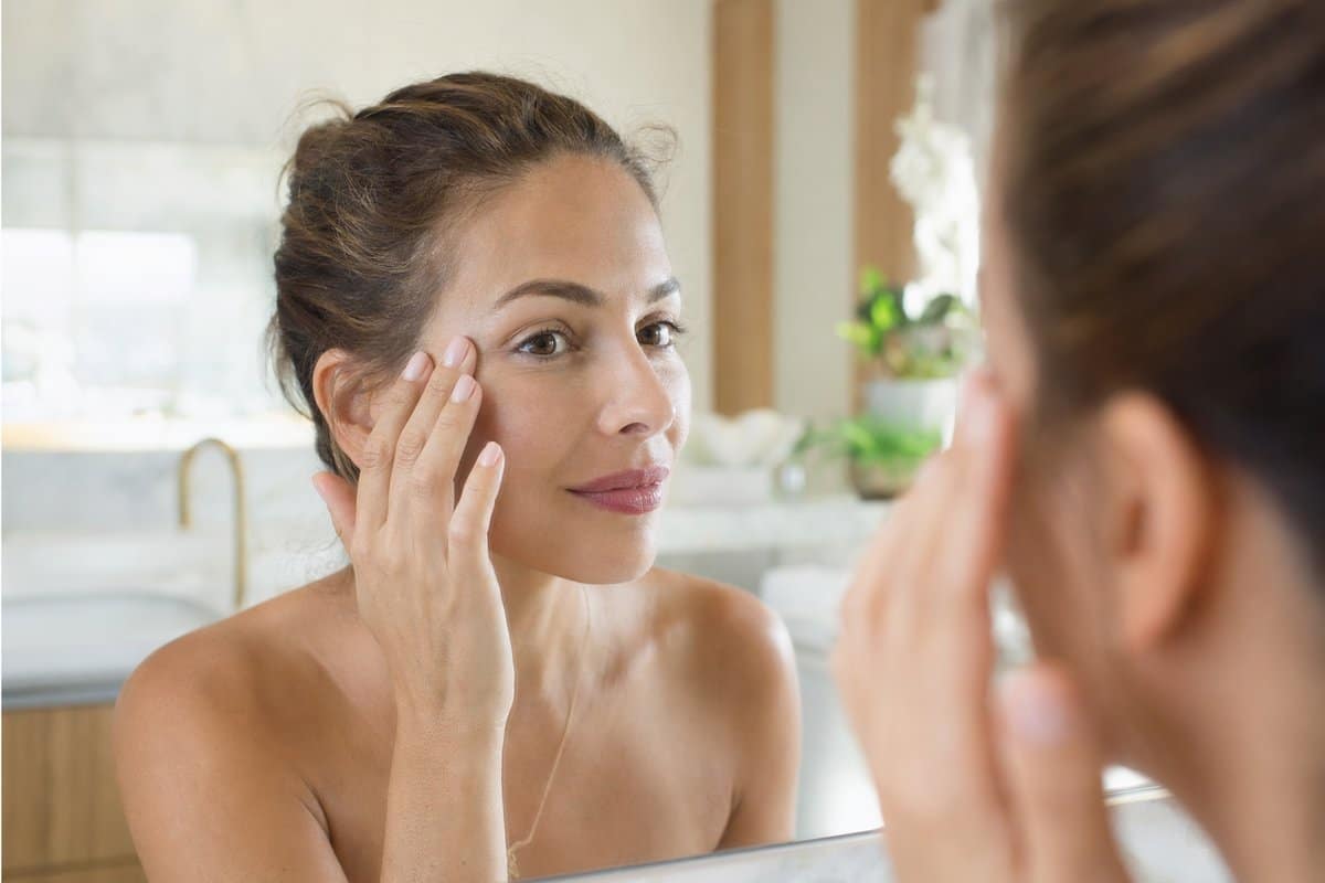 Woman examining smooth crow's feet after Botox treatment in Miami Lakes