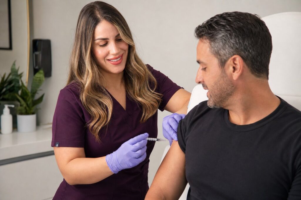 Clinician at Miami Lakes Med Spa administering a weekly GLP-1 weight loss injection to a male patient's upper arm